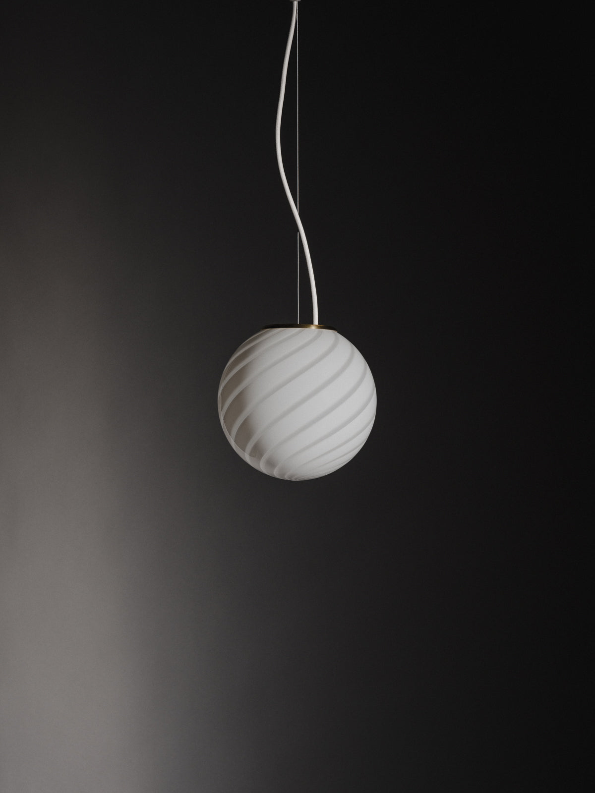 Sphere-shaped pendant lamp crafted from mouth-blown opaline glass. The design features a swirl pattern obtained using an original 1970s mould, specifically picked to give the lamp a clean expression. The piece includes a hand-casted fitting in solid brass. Handmade in Murano, Italy. Murano pendel loftslampe loftlampe Copenhagen Venice